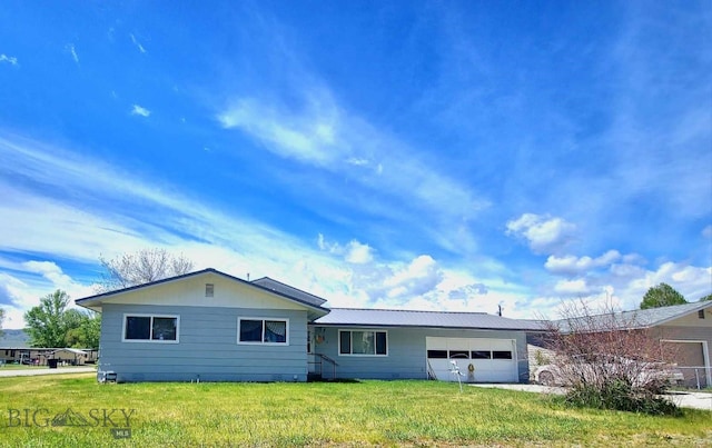 single story home with a garage and a front lawn