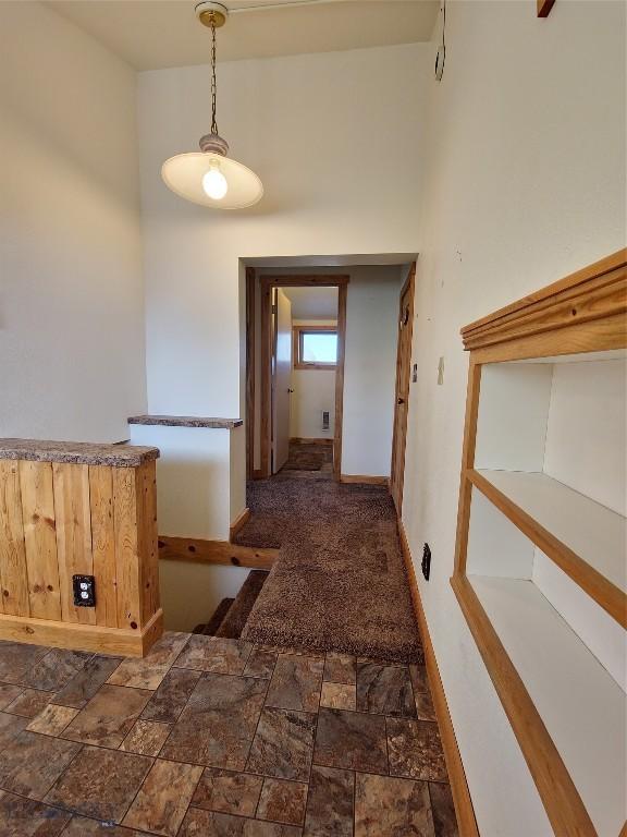 512 S Oak, Townsend, MT 59644 - corridor with baseboards and stone finish floor