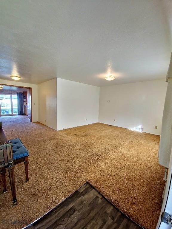 512 S Oak, Townsend, MT 59644 - spare room with dark carpet