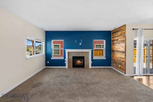 unfurnished living room with a fireplace and carpet floors