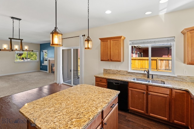 kitchen featuring light stone countertops, sink, black dishwasher, dark hardwood / wood-style floors, and pendant lighting