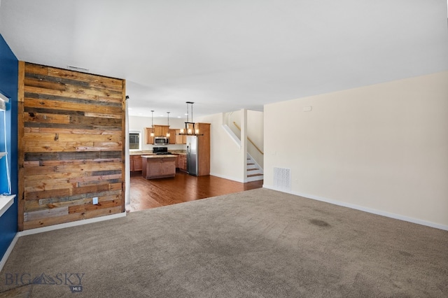 unfurnished living room featuring dark carpet