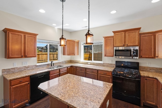 kitchen featuring sink, a center island, a wealth of natural light, and black appliances