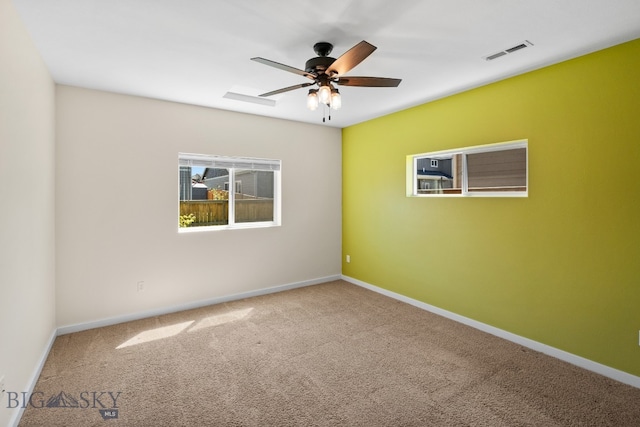 spare room with carpet floors and ceiling fan