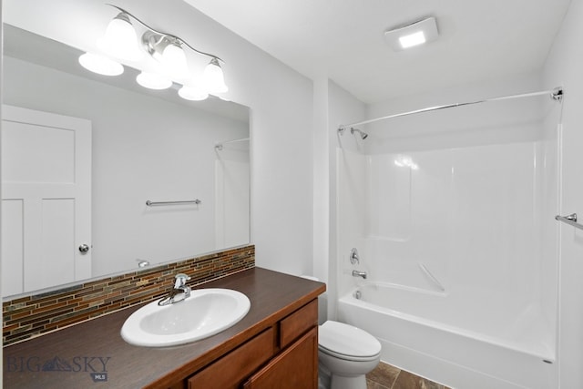 full bathroom with decorative backsplash, toilet, shower / bath combination, and vanity