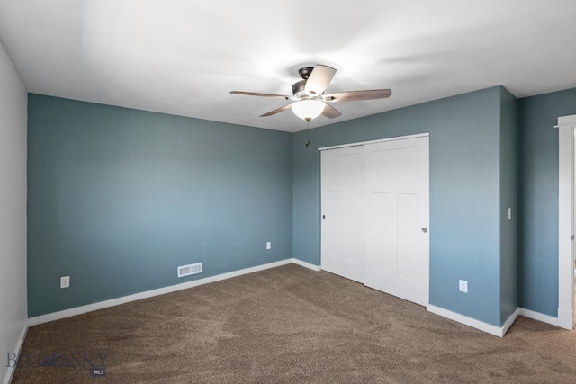 unfurnished bedroom with carpet, a closet, and ceiling fan