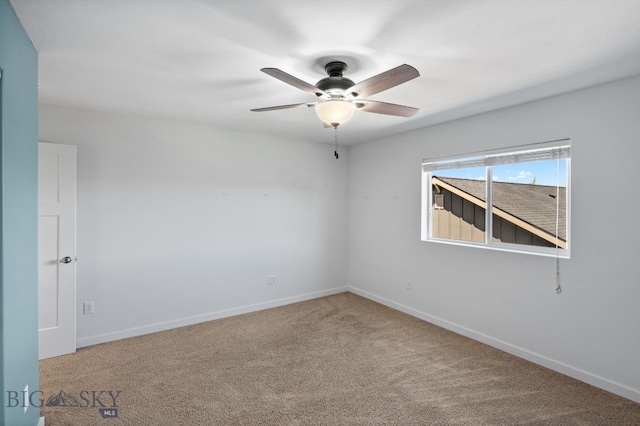 spare room featuring carpet floors and ceiling fan