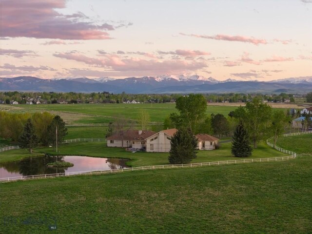 view of nearby features with a rural view, a water and mountain view, and a yard