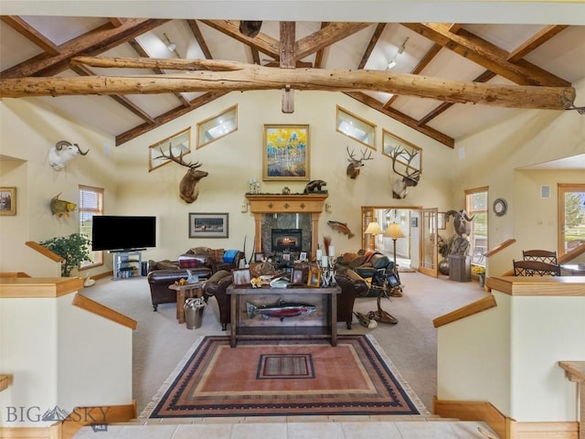 carpeted living room with high vaulted ceiling, a fireplace, and beam ceiling