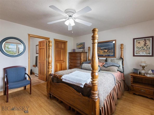 bedroom with a ceiling fan and light wood-style floors