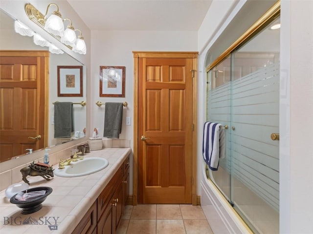 full bathroom with shower / bath combination with glass door, vanity, and tile patterned floors