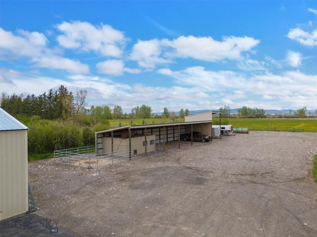 view of outdoor structure featuring an outbuilding, a rural view, and an exterior structure