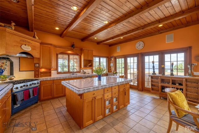 5275 Riverview Dr, Helena, MT 59602 - kitchen featuring high end stainless steel range, a wooden ceiling with exposed beams, light tile patterned floors, tasteful backsplash, and french doors