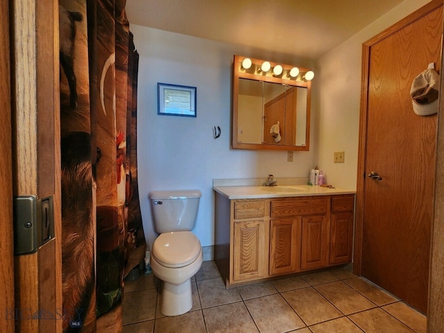 bathroom with tile patterned floors, vanity, and toilet