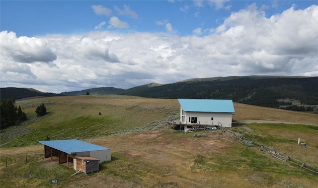 drone / aerial view featuring a mountain view and a rural view