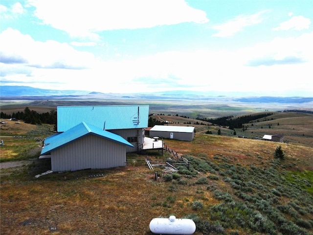 view of side of property with a mountain view and a rural view