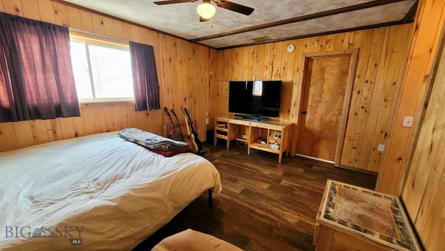 bedroom with dark hardwood / wood-style floors, wooden walls, and ceiling fan