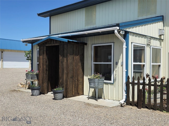 view of side of home featuring an outbuilding