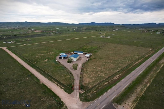 drone / aerial view with a mountain view and a rural view