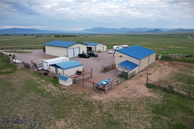 view of pool featuring a storage shed, a mountain view, and a rural view