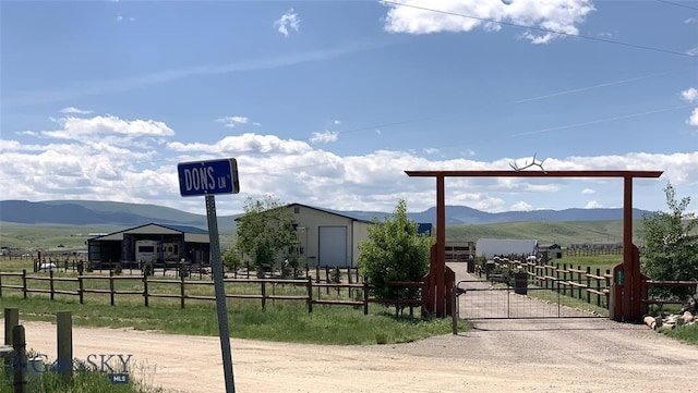 view of gate featuring a mountain view and a rural view