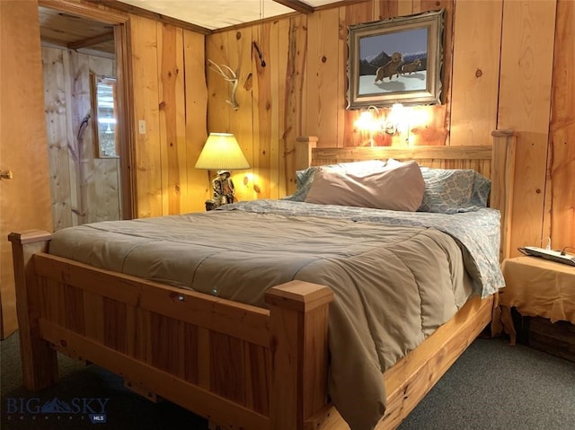 bedroom with carpet flooring and wooden walls