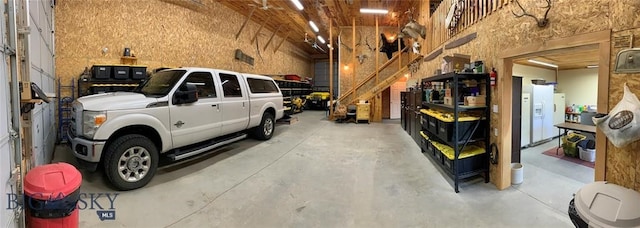 garage with white fridge with ice dispenser