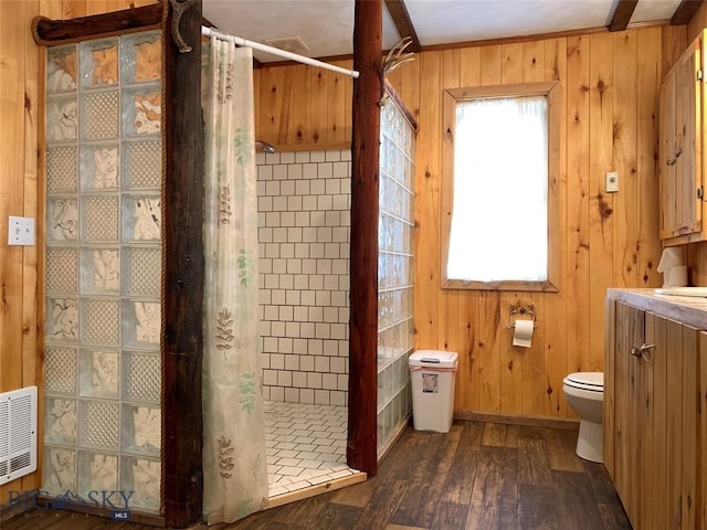 bathroom with vanity, wood-type flooring, a shower with curtain, wood walls, and toilet