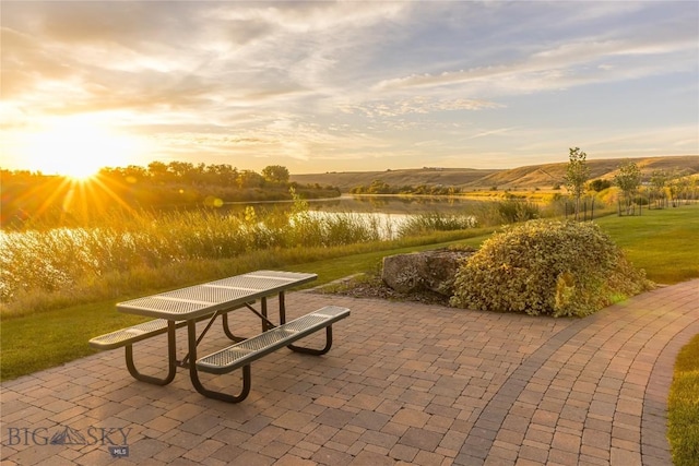 view of home's community with a mountain view and a patio