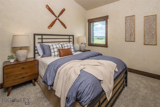 bedroom featuring carpet floors and vaulted ceiling