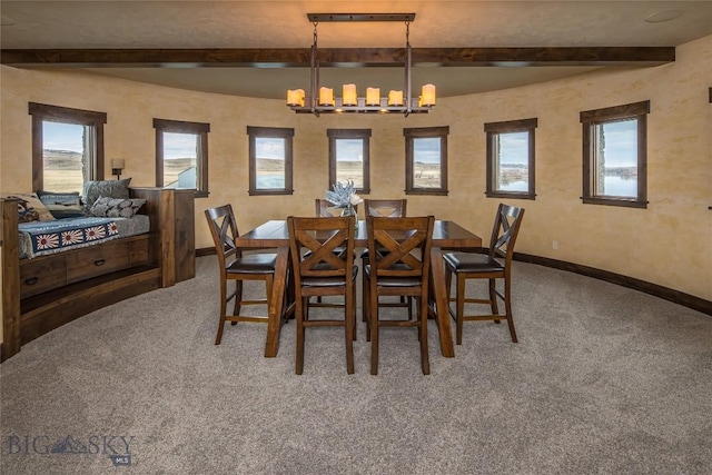 carpeted dining area with an inviting chandelier, beam ceiling, and plenty of natural light