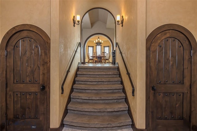 stairway featuring lofted ceiling