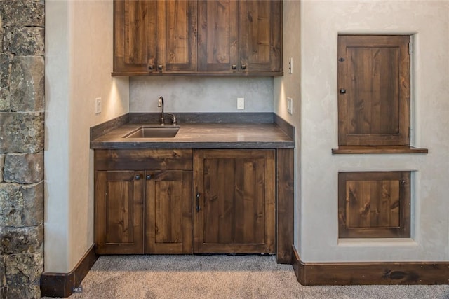 kitchen featuring carpet floors and sink