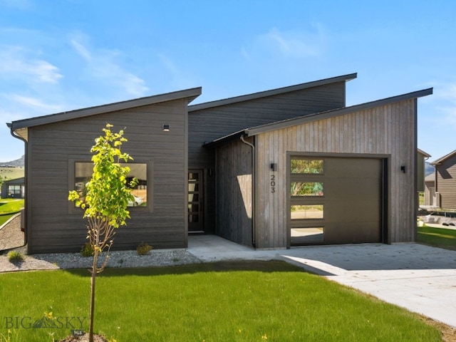 modern home with a garage and a front lawn