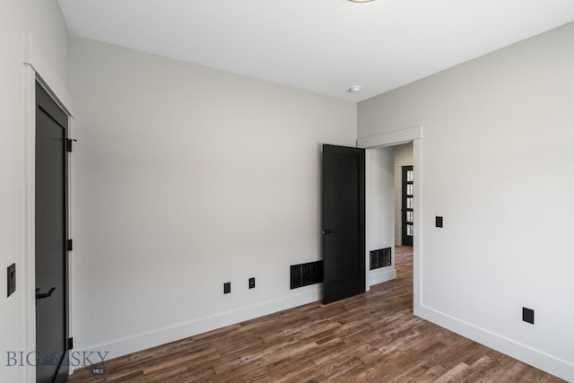 spare room with hardwood / wood-style floors