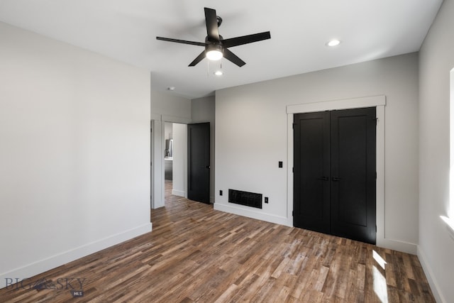 interior space with ceiling fan and hardwood / wood-style flooring