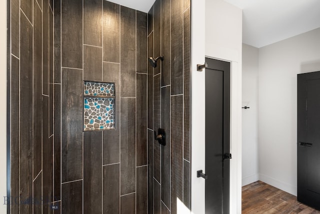 bathroom featuring hardwood / wood-style flooring and a shower