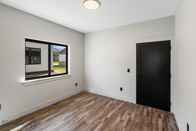 unfurnished room featuring wood-type flooring