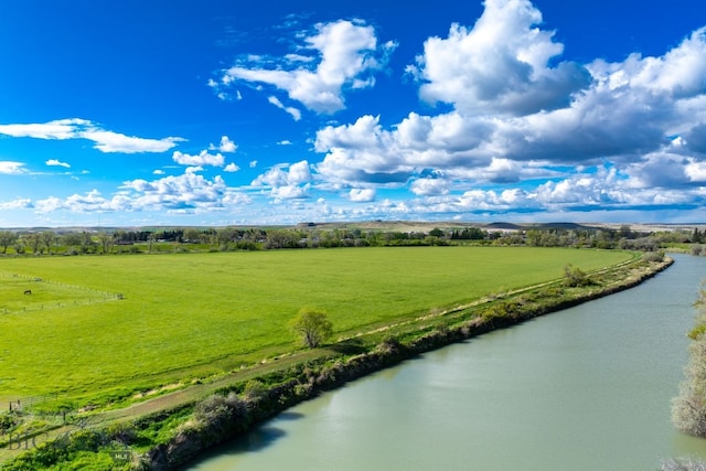 drone / aerial view featuring a water view and a rural view