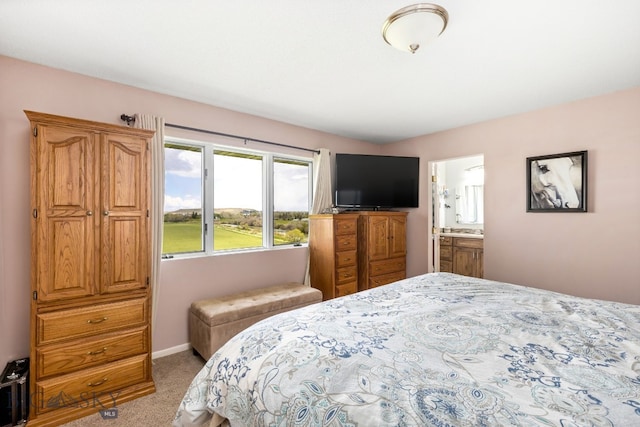 carpeted bedroom featuring ensuite bathroom