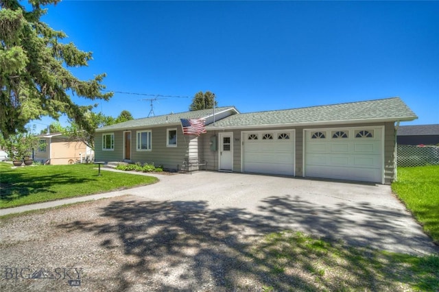 ranch-style house with a garage and a front yard