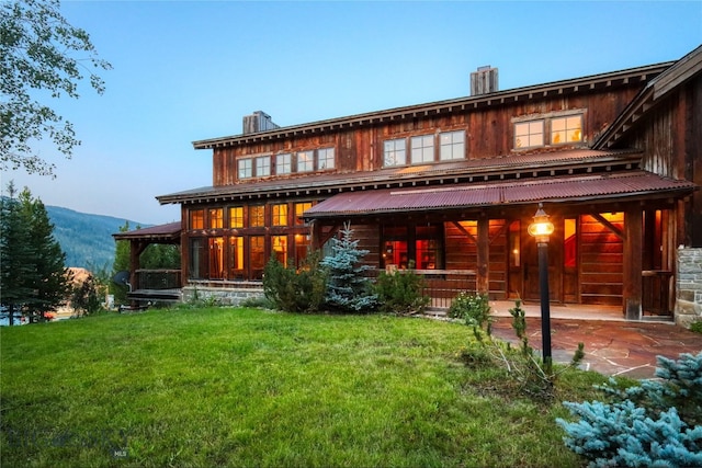 back house at dusk with a yard