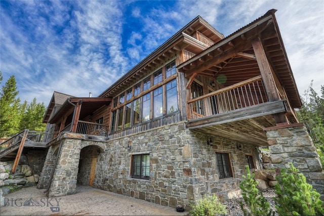 rear view of house featuring a balcony