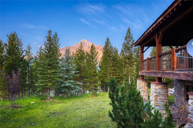 view of yard featuring a deck with mountain view