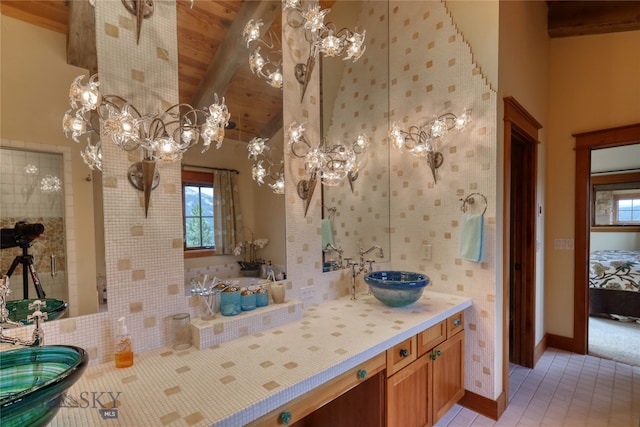 bathroom featuring a notable chandelier, tile flooring, and vanity