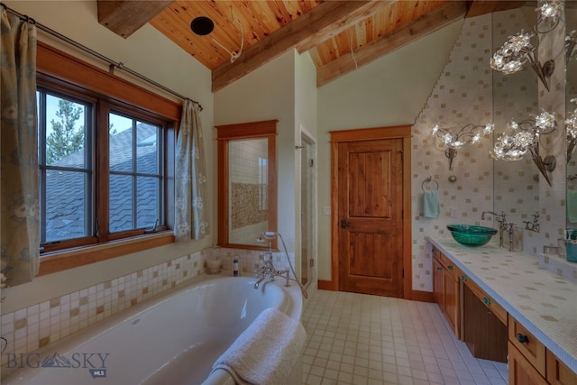 bathroom featuring a relaxing tiled bath, vaulted ceiling with beams, tile flooring, wood ceiling, and vanity