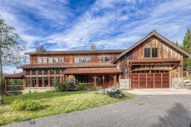 view of front of home with a garage and a front lawn