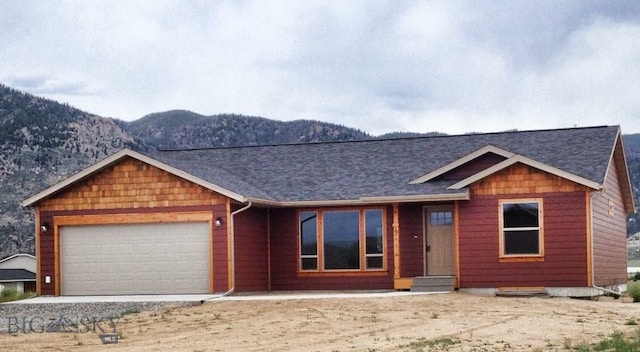 view of front of house featuring a garage and a mountain view