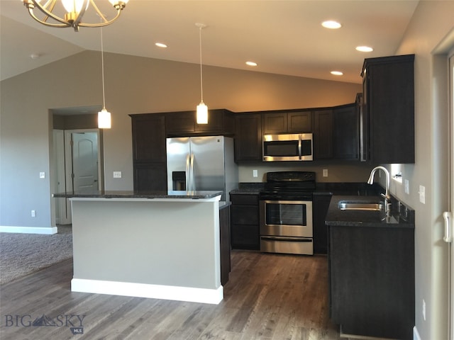 kitchen featuring dark wood-type flooring, a kitchen island, appliances with stainless steel finishes, pendant lighting, and sink