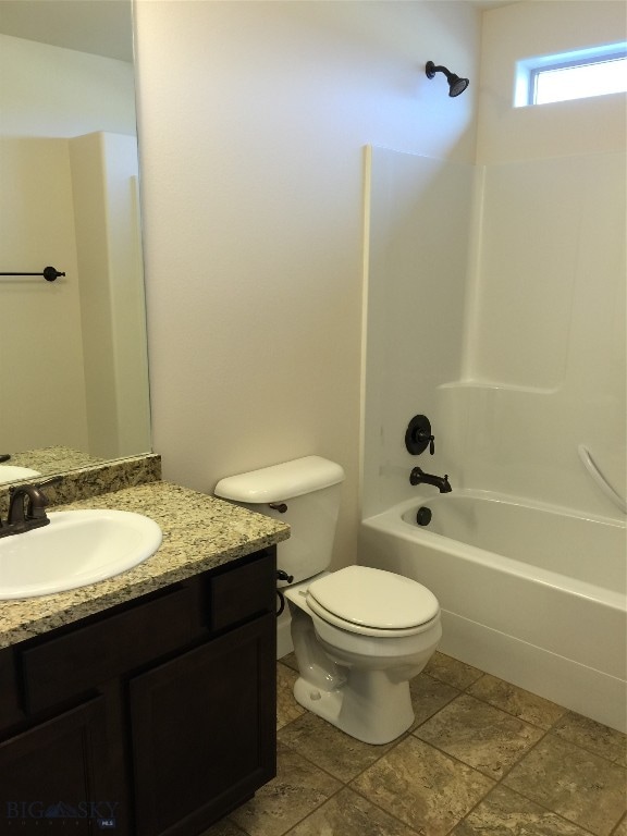 full bathroom featuring tile flooring, shower / bath combination, vanity, and toilet